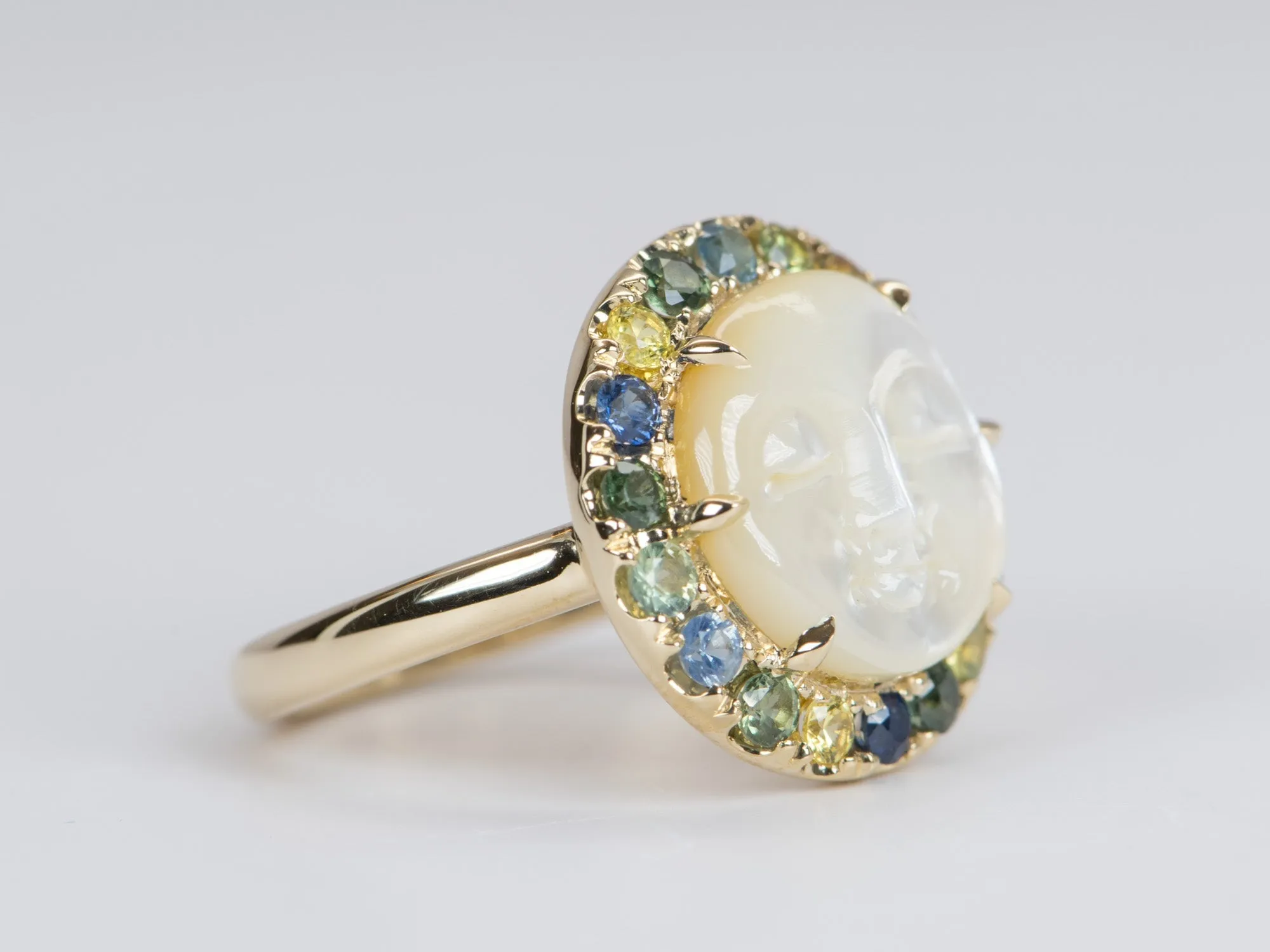 Carved Mother of Pearl Moon Face Disk Ring with Teal Sapphire Gemstone Halo 9K Gold R6367